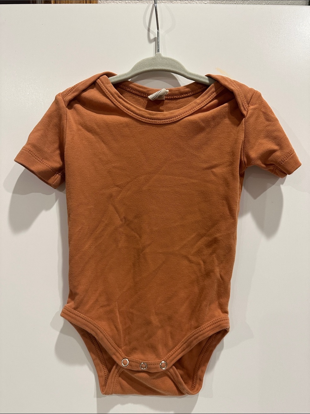Kate Quinn Organic One-Piece Bodysuit in Rust